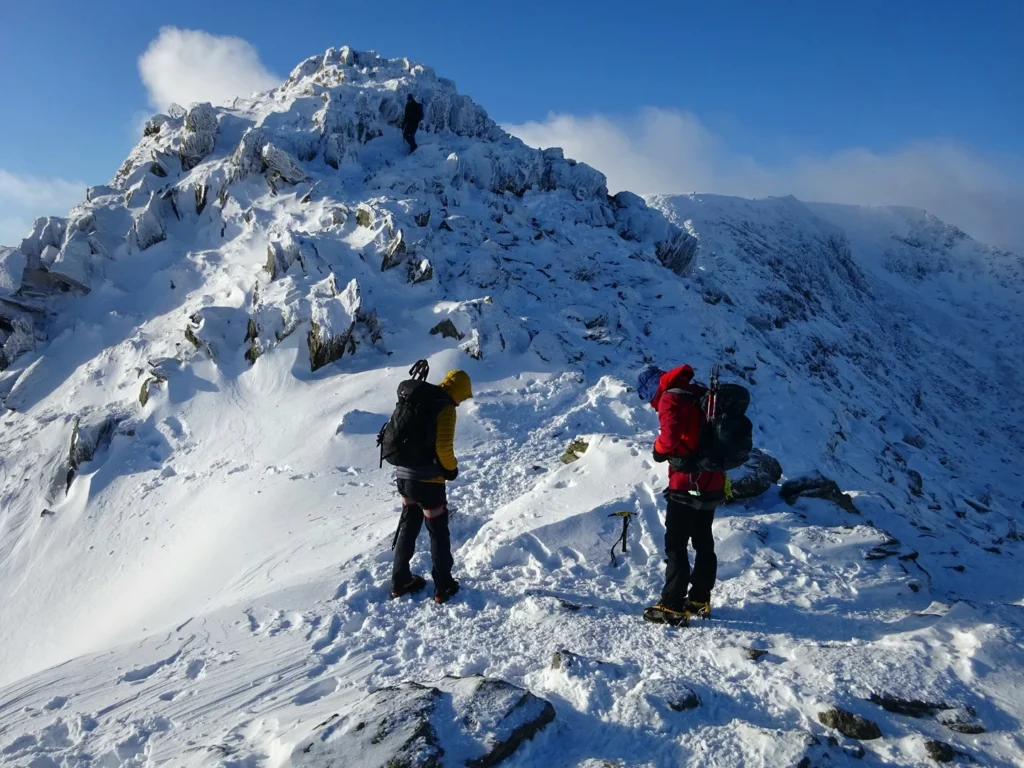 snowy ridge with two mountaineers
