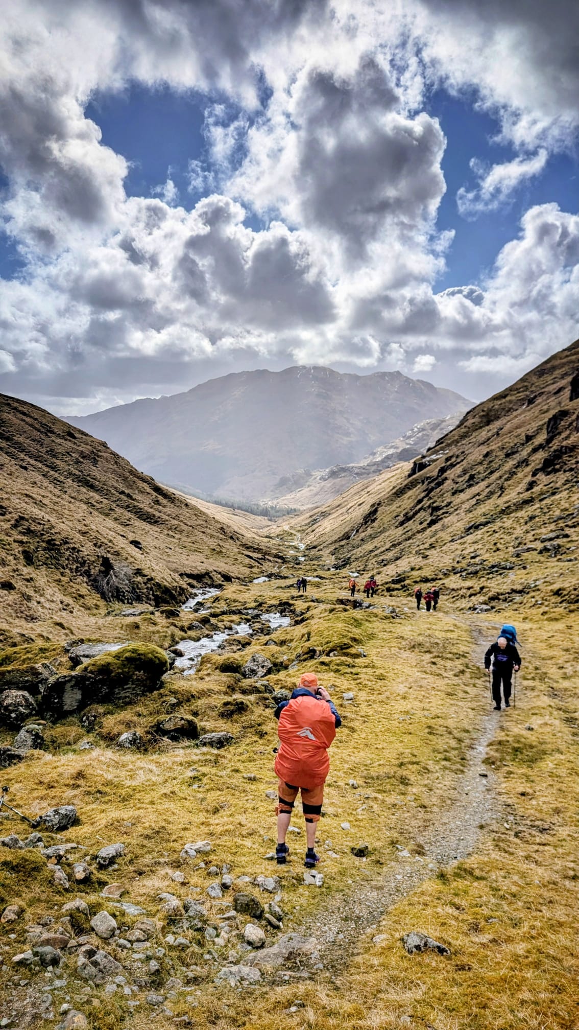 Hikers walking through a Knoydart valley carrying packs on a multi-day expedition