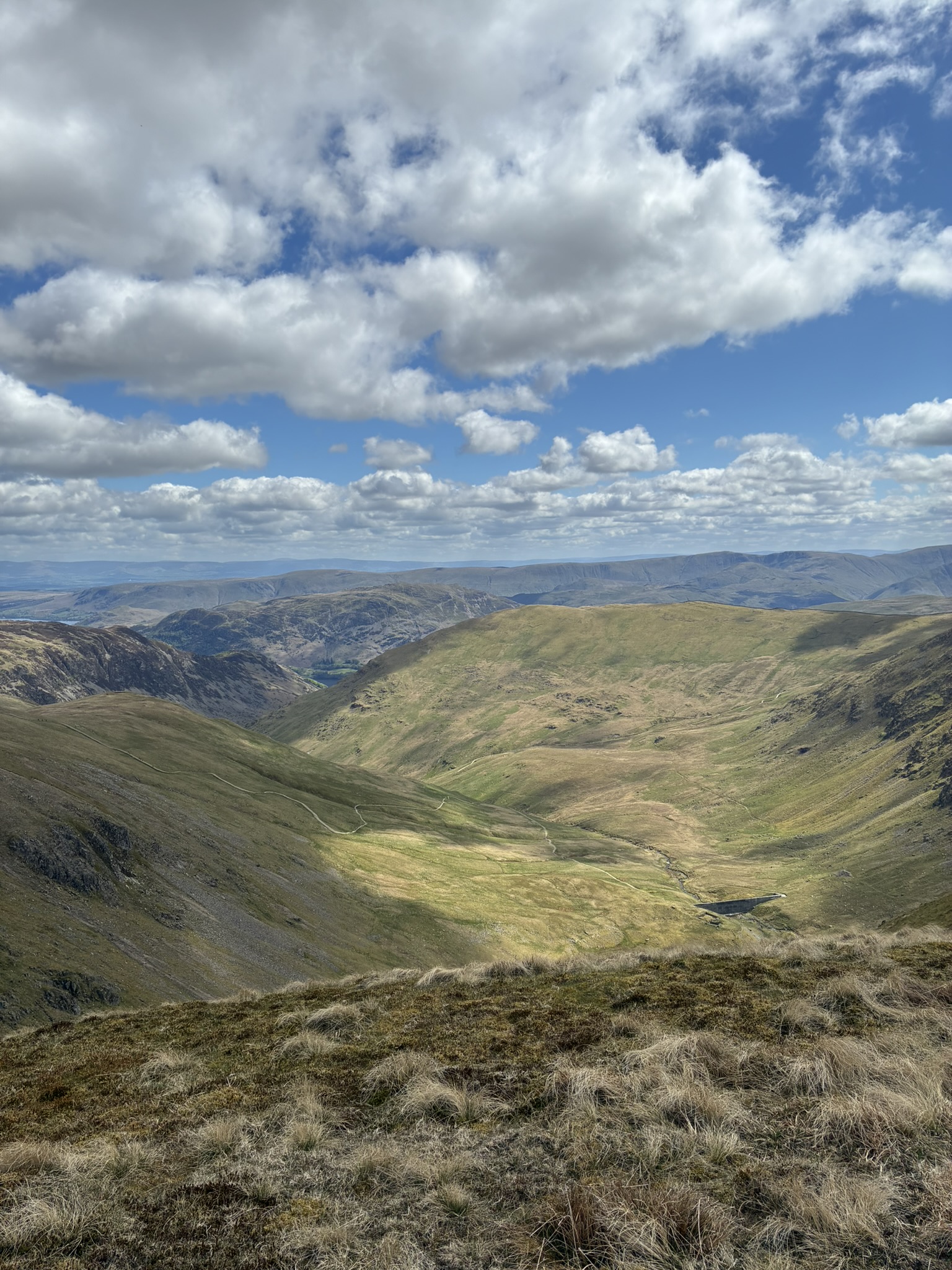 Wide panoramic view across the Lake District mountains during a guided overnight wild camping adventure