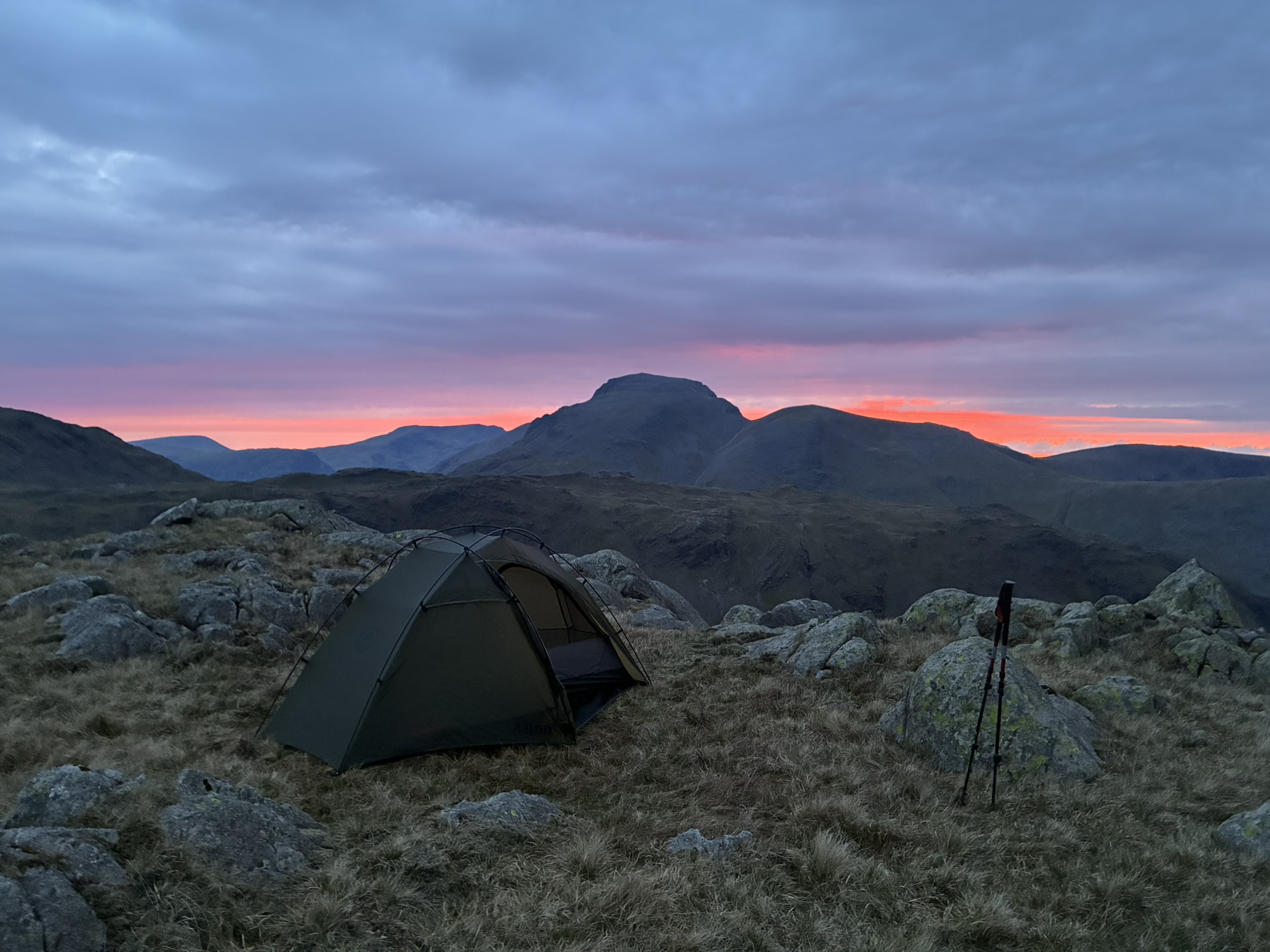 Sunset over a mountain wild camp in the Lake District