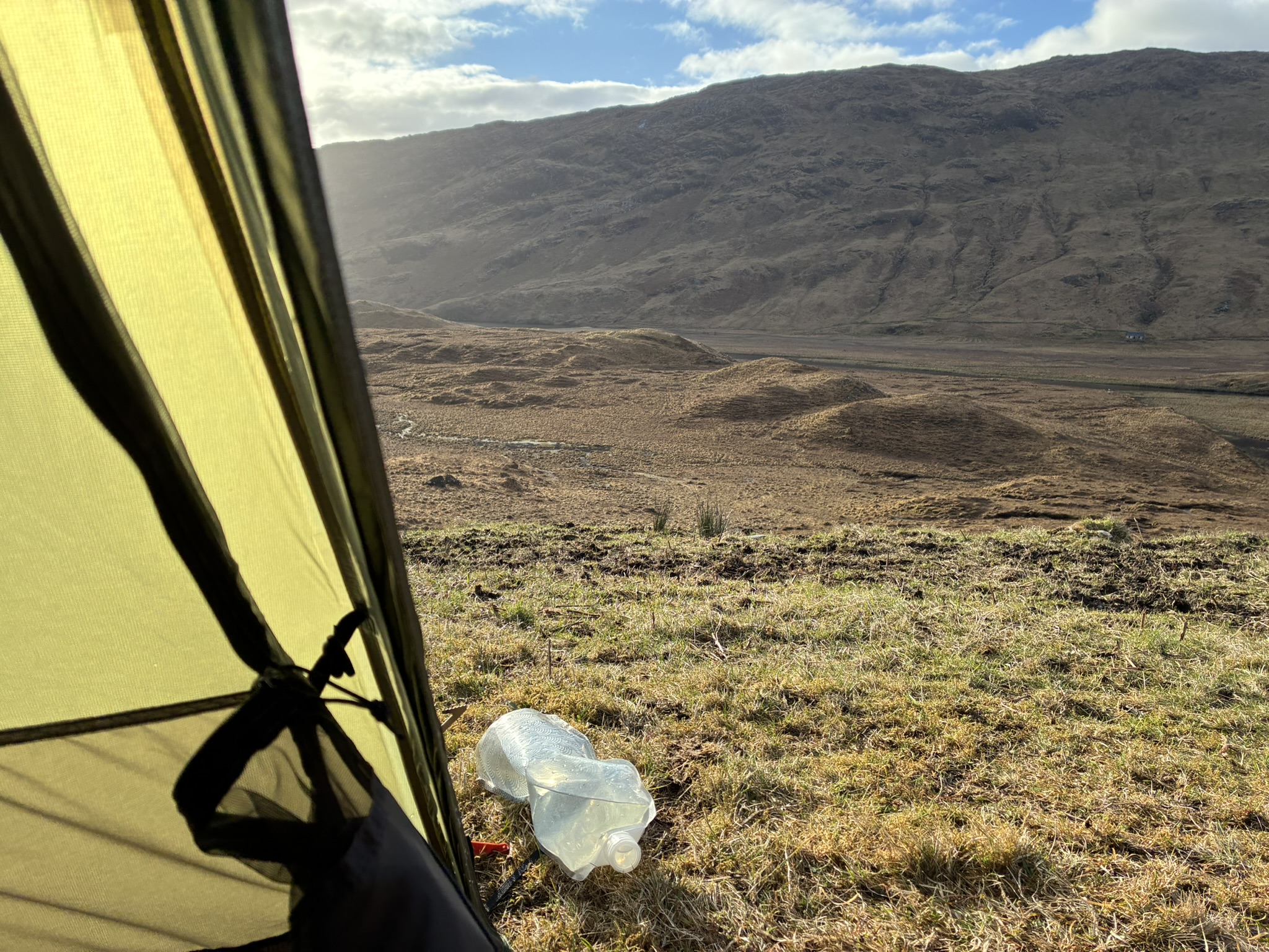 View from tent across remote Scottish wilderness campsite