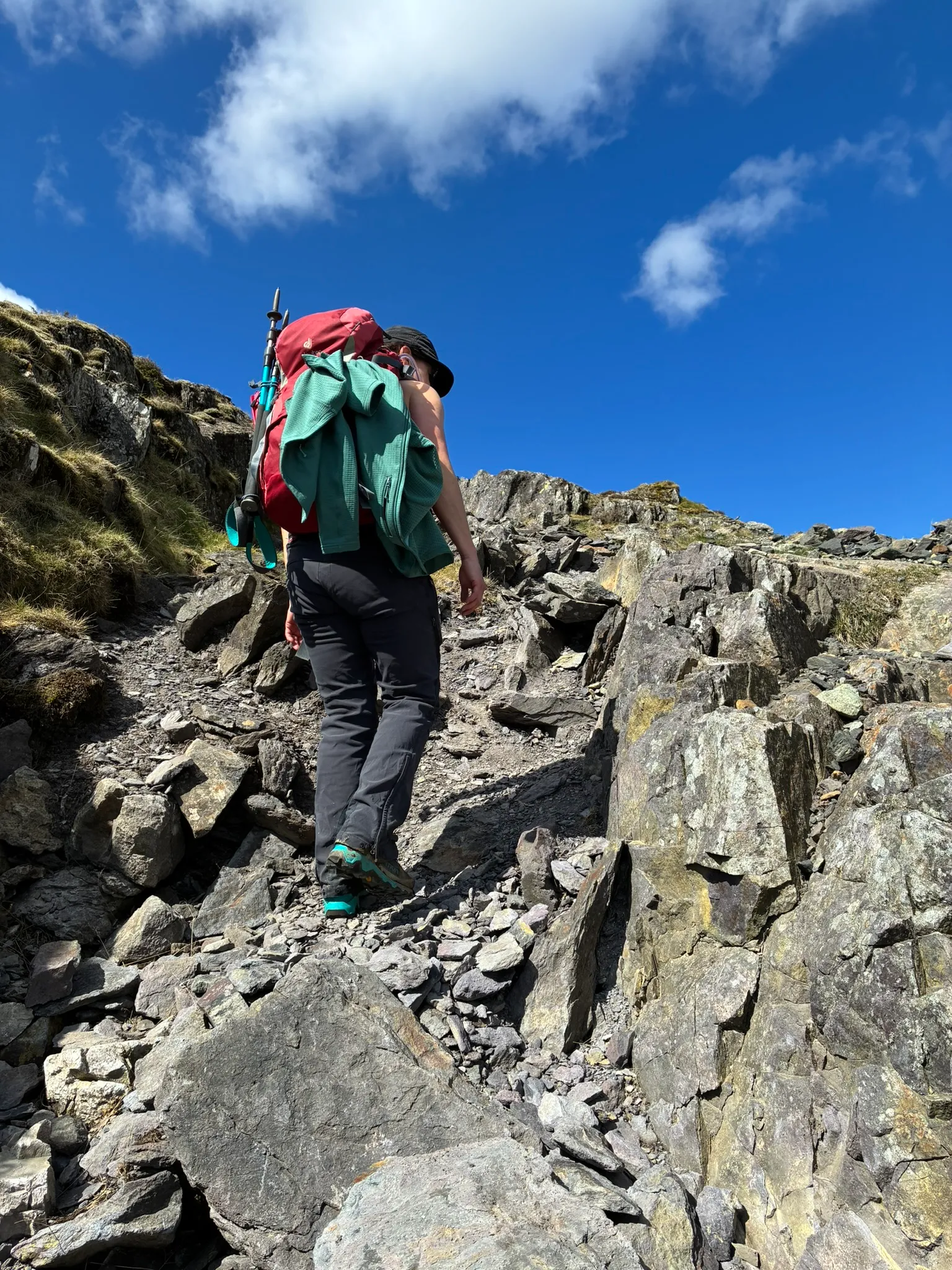 Walker on rocky Helvellyn ground during a guided Lake District walk